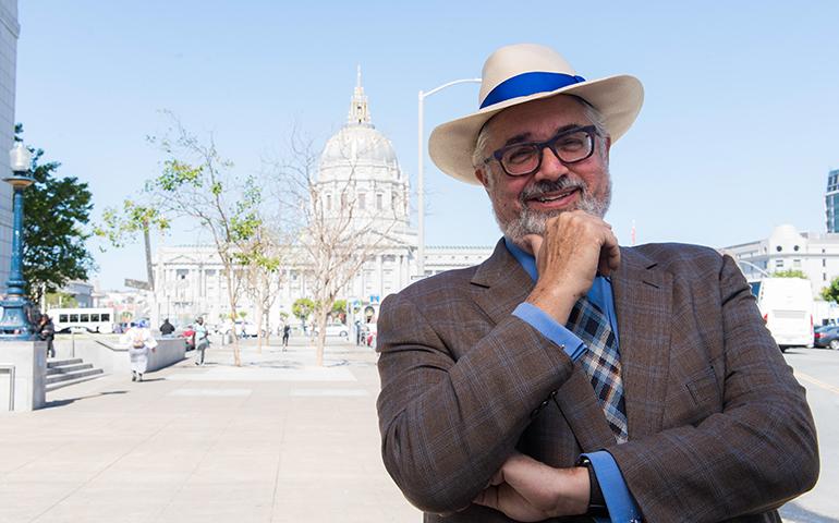 Image of retiree wearing hat in Civic Center with City Hall in the background.