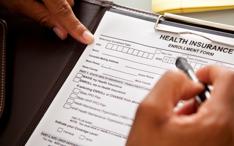 Photo of a person filling out a health form.
