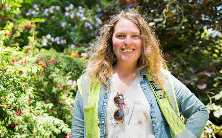 Image of female gardener from the Recreation and Parks Department of San Francisco standing outside with her arm on her side.