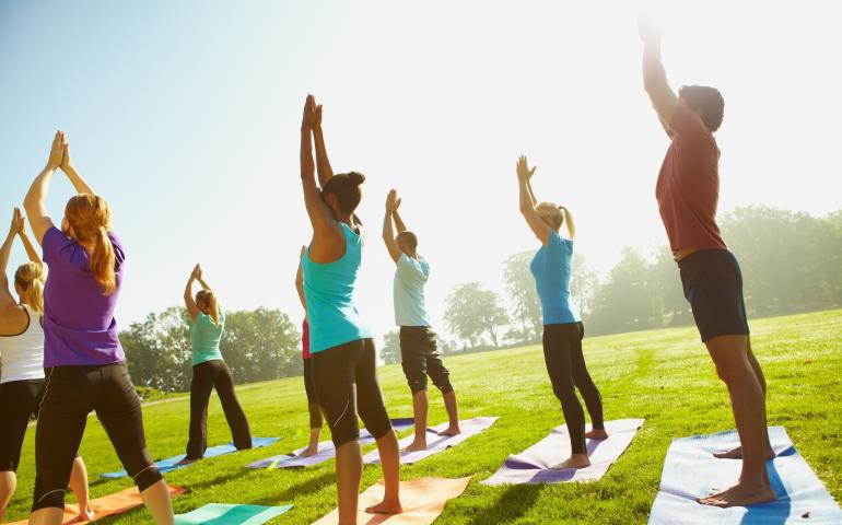 group outside doing yoga