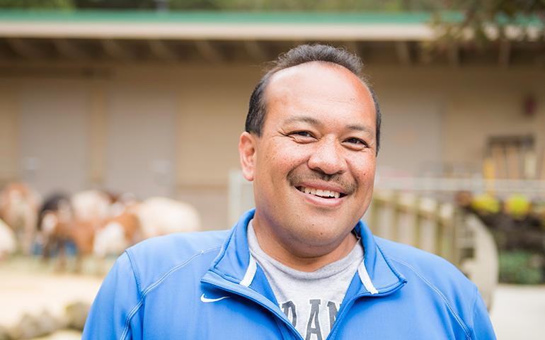 Image of a male San Francisco employee from Laguna Honda Hospital posing in front of the animal farm located behind the building.