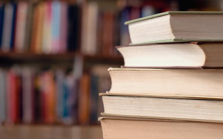 Stack of books on a table in a library.