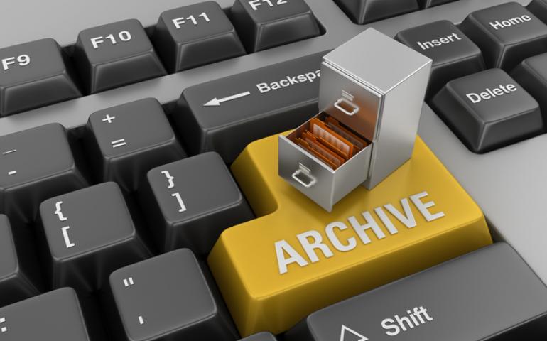 Keyboard with a large yellow button titled "Archive" and a small filing cabinet on top.