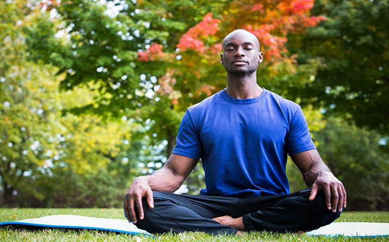 Man performing yoga outside