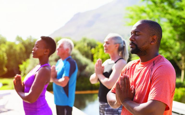 Mental Health Awareness - Whole Person Well-Being People practicing yoga outside