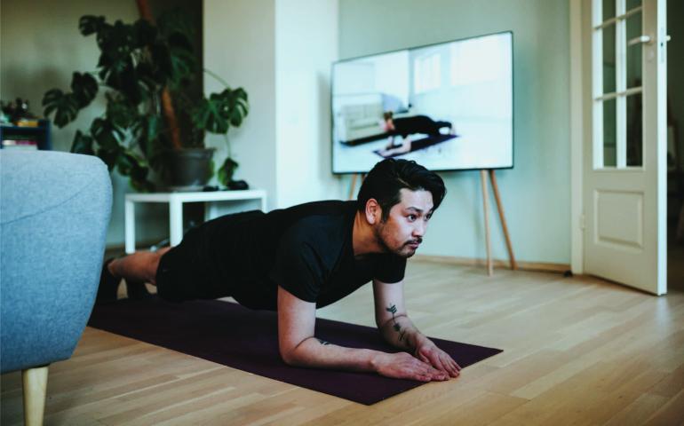Man Holding a Plank on a yoga Mat