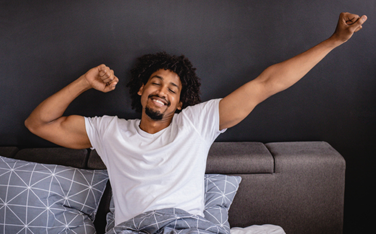 Man stretching In Bed