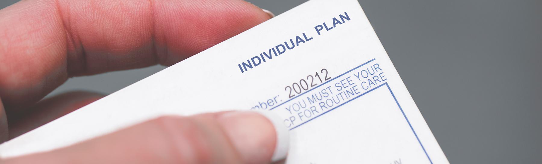 Photo of a hand holding a generic medical plan insurance card