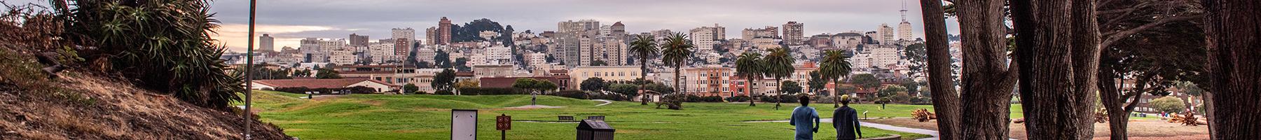 Photo of two people jogging through Fort Mason Park.