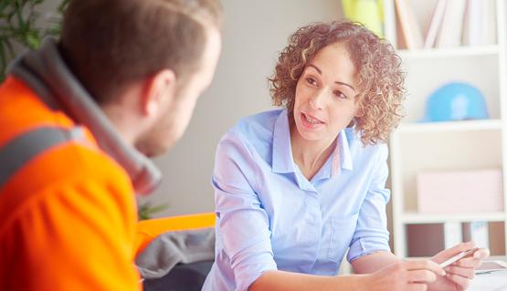 Two people talking at table EAP